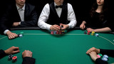Casino poker dealer holding cards ready to start game at casino, risky gambling