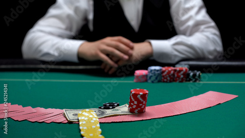 Raising stakes at casino, man making risky business investment, gambling