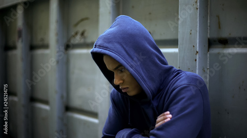 Canvas Print Antisocial teenager hiding from people, protesting against rules and injustice