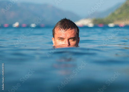 Nice guy bathing in the sea © StockBox