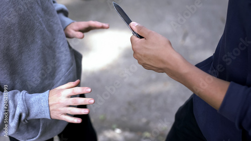 Afro-american criminal threatening male with knife, attacking victim, extortion