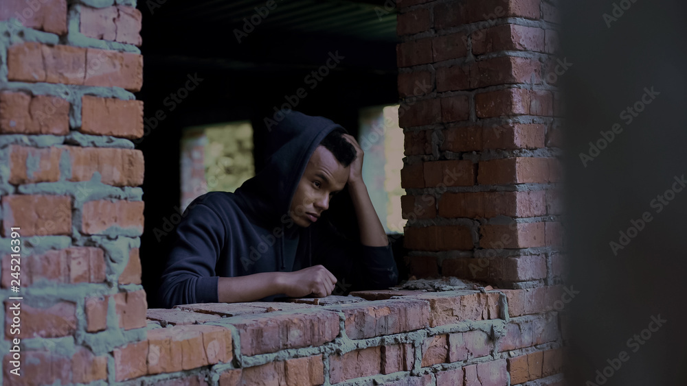 Depressed teenager among ruins, poor homeless people abandoned by society