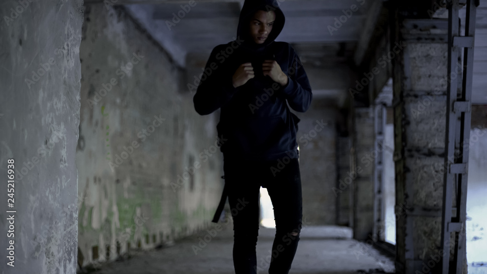 Afro-american walking in abandoned building, has no friends, racism problem Afro-american walking in abandoned building, has no friends, racism problem