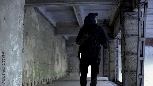 Teenage boy walking in abandoned house, dangerous place, risk of kidnapping © motortion