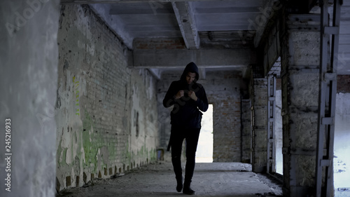 Lonely boy walking in abandoned building, afro-american has no friends, racism © motortion
