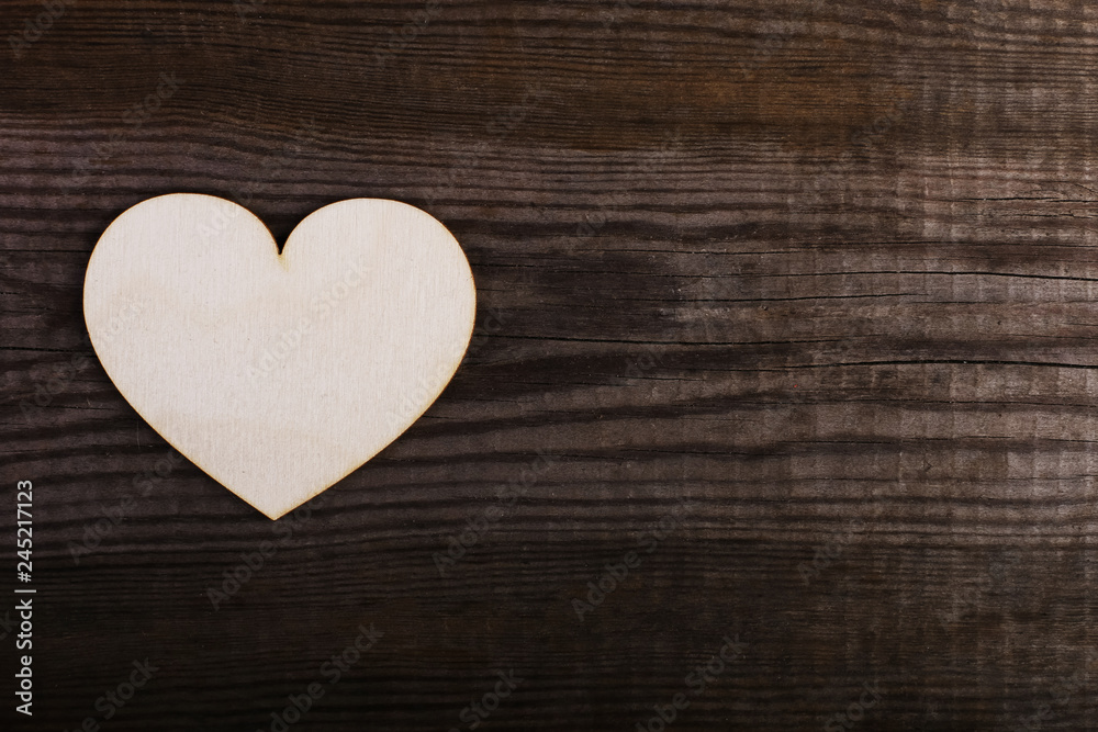 Wooden heart on the old table. Handmade blank for greeting card, copy space.