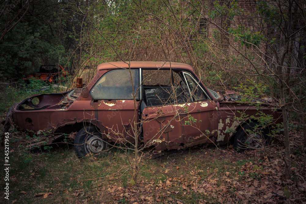 Destroyed and abanoded car in an abandoned place