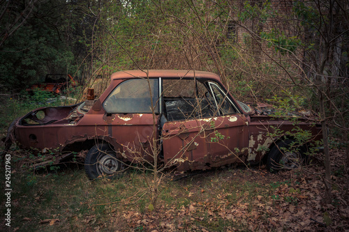 Destroyed and abanoded car in an abandoned place