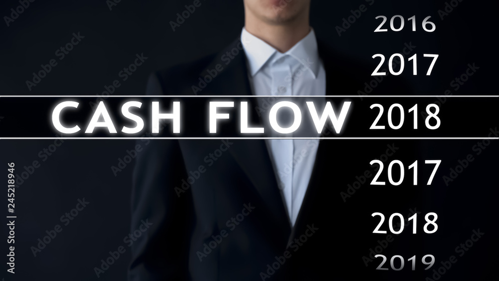 Cash flow for 2018, businessman selects financial report on virtual screen Cash flow for 2018, businessman selects financial report on virtual screen