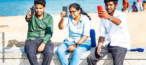 Photography Two men one woman taking selfies at the beach with sea in background