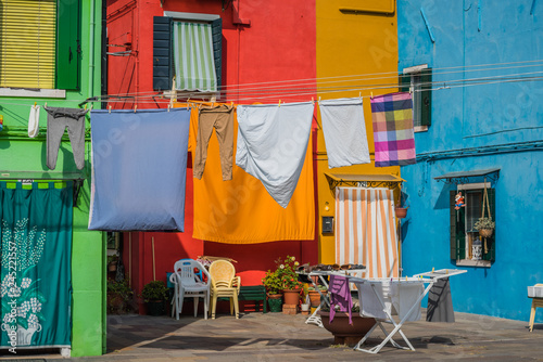 Clothes drying on washing line in front of residential houses photo