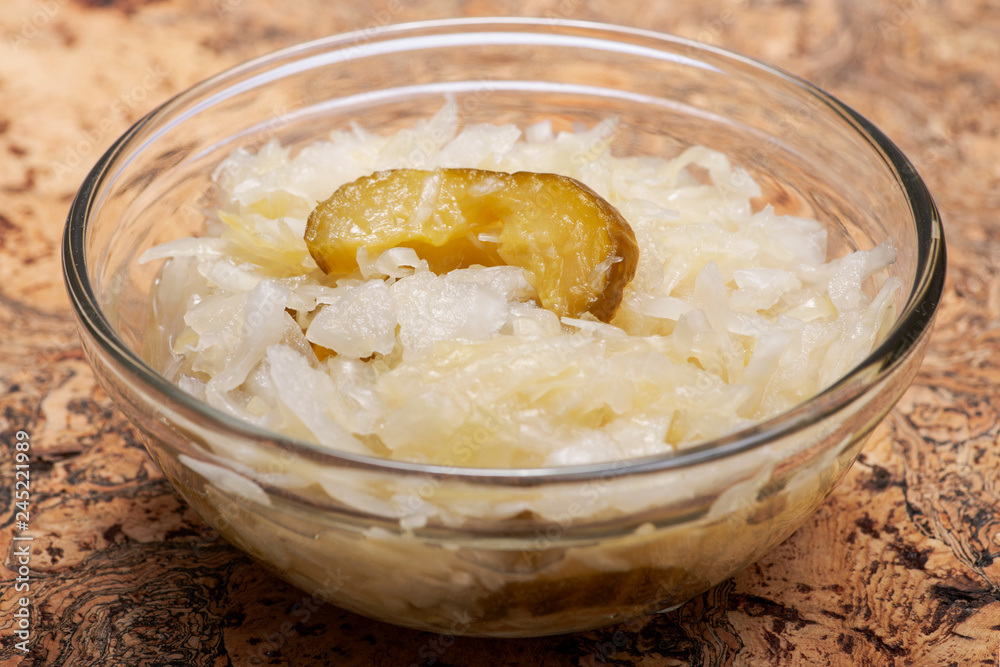 Traditional organic raw and fermented sauerkraut with pickled Persian cucumbers. Traditional organic raw and fermented sauerkraut with pickled Persian cucumbers.