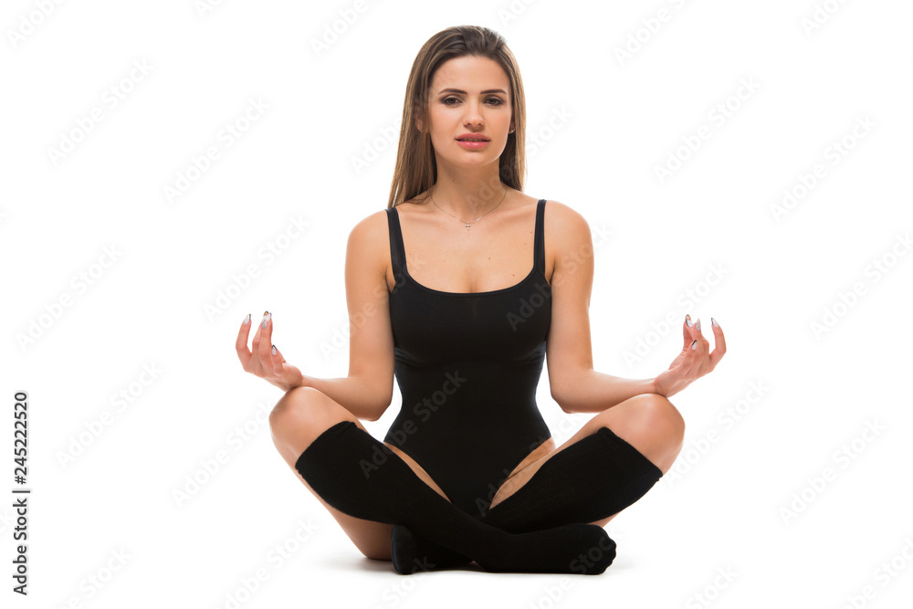 Sporty young woman wearing sport clothes in lotus pose. Slim Female doing yoga practice isolated on white background. Concept of healthy life Sporty young woman wearing sport clothes in lotus pose. Slim Female doing yoga practice isolated on white background. Concept of healthy life