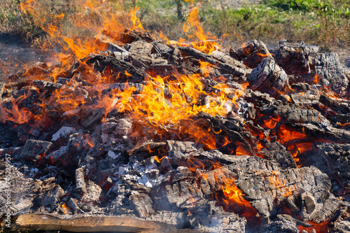 A large fire burning in the open.