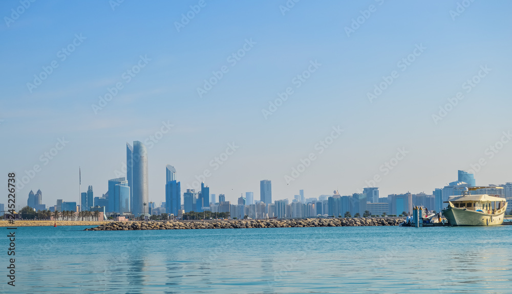 Fototapeta premium Abu Dhabi city skyline along Corniche beach taken from a boat