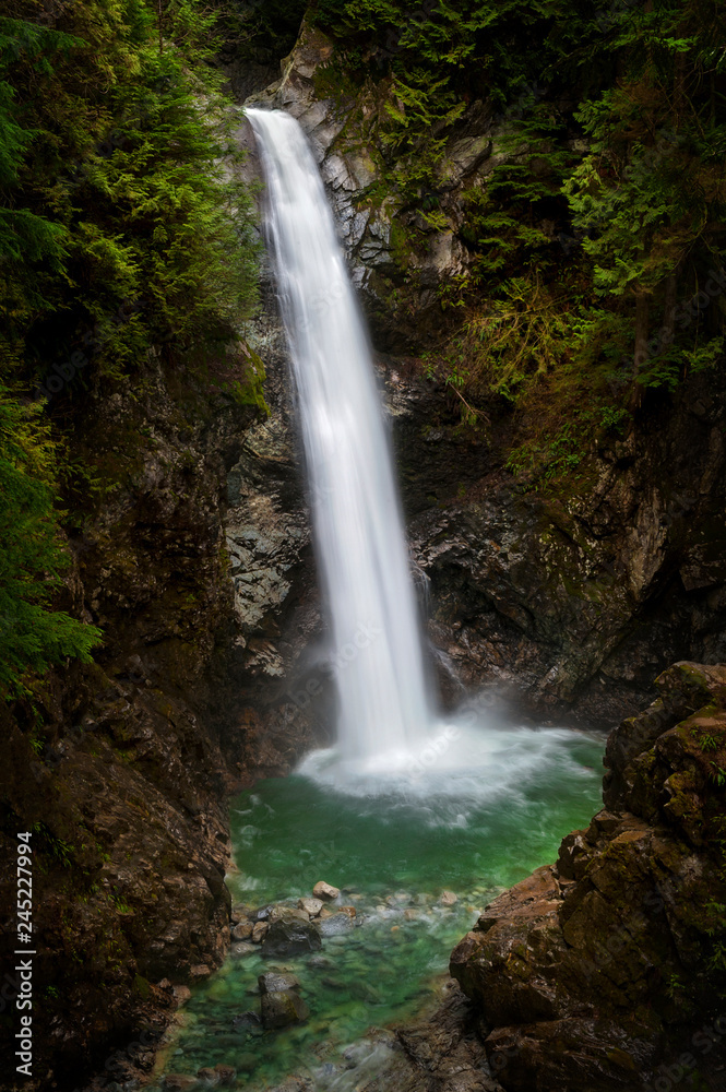 Cascade Falls Regional Park. Located Northeast of Mission, British Columbia, Cascade Falls is a scenic waterfall that can be viewed from a suspension bridge that crosses the river. Cascade Falls Regional Park. Located Northeast of Mission, British Columbia, Cascade Falls is a scenic waterfall that can be viewed from a suspension bridge that crosses the river.