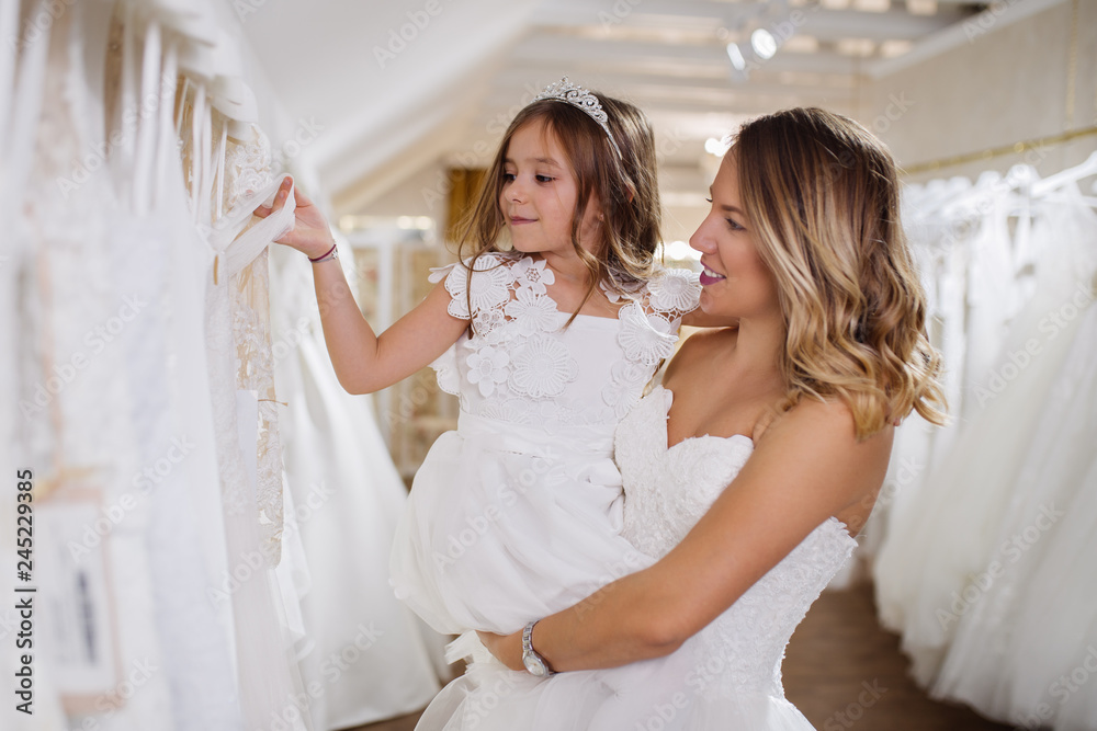 Bride with flower child or bridesmaid preparing for wedding. Bride with flower child or bridesmaid preparing for wedding.