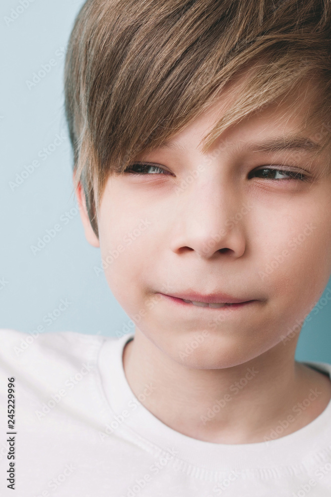 Thoughtful boy with bitter prank bitten his lower lip with his teeth and narrowed his eyes Thoughtful boy with bitter prank bitten his lower lip with his teeth and narrowed his eyes