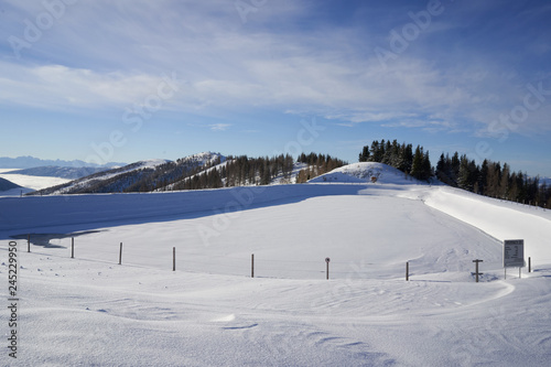 Brunnach Ski Resort, St. Oswald, Carinthia, Austria - January 20, 2019: View to the landscaped water reservoir in the Brunnach ski resort, St. Oswald, Austria