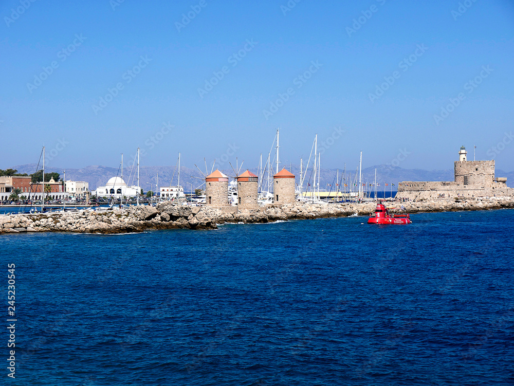 The windmills on Mandraki Harbour on the island of Rhodes a popular tourist attraction