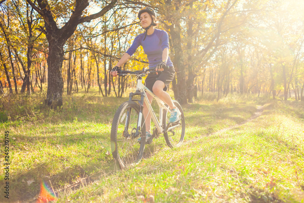 Naklejka premium Biking in the forest.