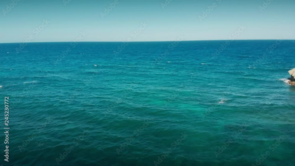 Flight over the sea, lonely little islands near the shore line Flight over the sea, lonely little islands near the shore line