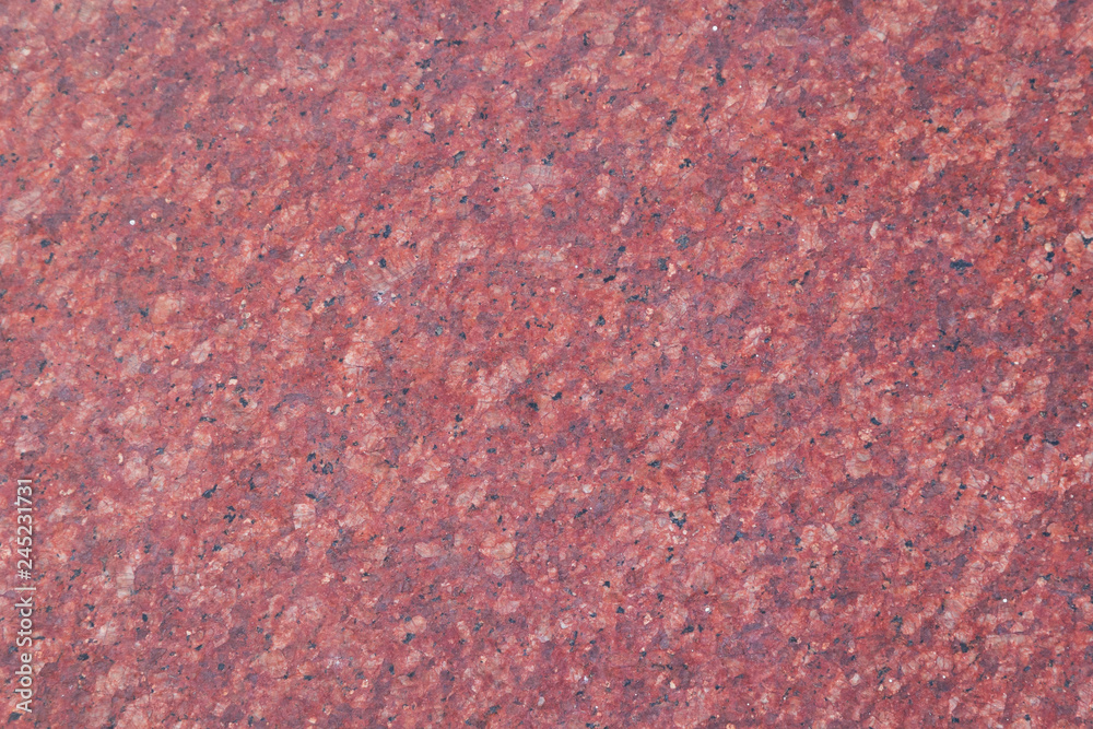 Close-up of a red smooth natural gemstone table background. Close-up of a red smooth natural gemstone table background.