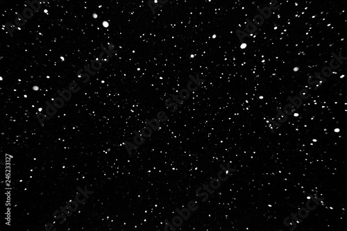 falling snow on a black background, snowfall at night, white spots on a black background