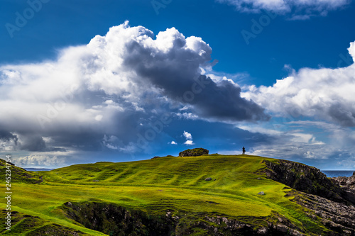 Single Person Stands On The Edge Of Cliffs At The Spectacular Atlantic Coast At Clachtoll Beach Near Lochinver In Scotland photo
