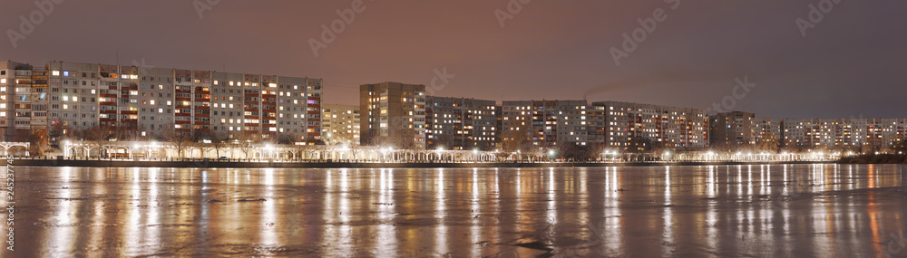 night city view from the frozen reservoir / panorama of the night city of the province of Ukraine