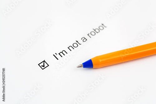 I'm not a robot - checkbox with a check mark on white paper with pen. Checklist concept