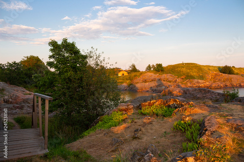 The rocky shore and bay of Suomenlinna Island in the Gulf of Finland is a beautiful traditional landscape of Finland, a summer evening in Finland.