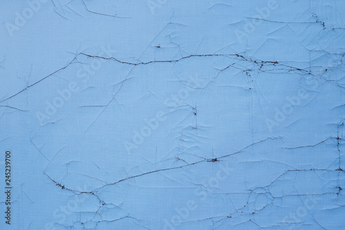 The texture of cracked banner fabric. Old textile surface blue. Perfect for background and design.