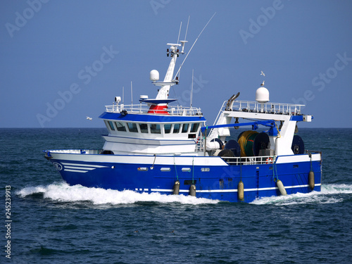 Modern trawler underway at sea to fishing grounds.