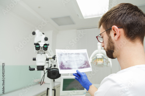 Dentist examines a snapshot of teeth