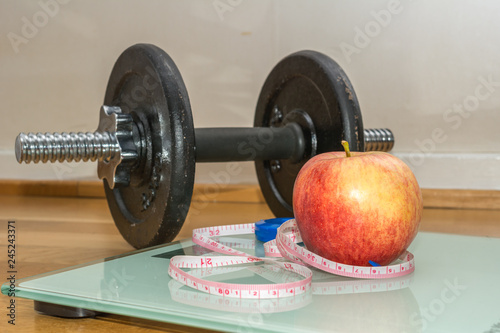 Concept - Getting in Shape, Measuring Tape, Apple, Scale and Dumbbell