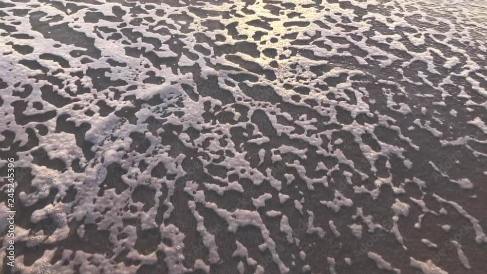 Happy Valentine's Day message handwritten in the sand revealed behind a foamy wave on the beach Happy Valentine's Day message handwritten in the sand revealed behind a foamy wave on the beach