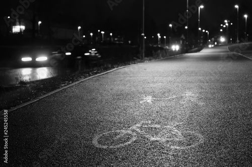 Asphalt way in Mostecka street in czech city of Chomutov  in rainy evening on 15th january 2019 photo