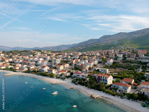 Scenic aerial bird view at morning coastal village near Split in Croatia, calm and quite tourist vocational hotel seafront under green mountains in Europe. 360 panoramic photography.