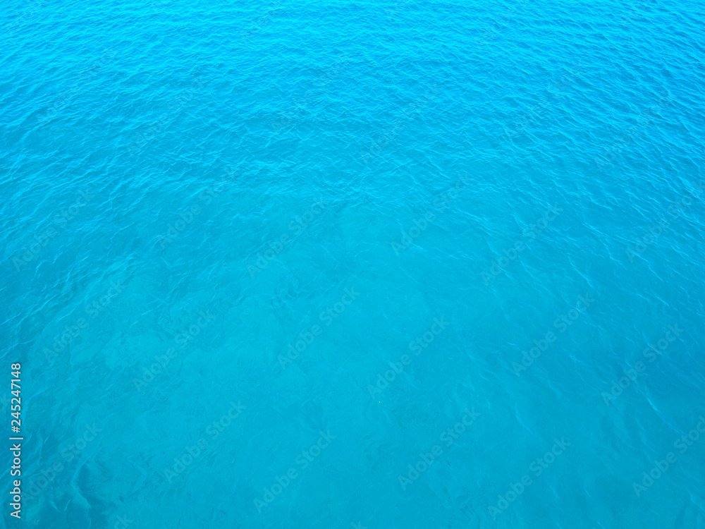 Aerial top water surface view background. Bird eye sea surface photo. Blue transparent crystal sea from above. Minimal. Near island Solta south of Split, Dalmatian archipelago, Croatia. Aerial top water surface view background. Bird eye sea surface photo. Blue transparent crystal sea from above. Minimal. Near island Solta south of Split, Dalmatian archipelago, Croatia.