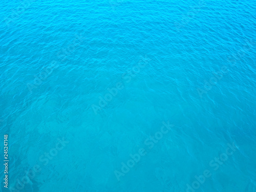 Aerial top water surface view background. Bird eye sea surface photo. Blue transparent crystal sea from above. Minimal. Near island Solta south of Split, Dalmatian archipelago, Croatia.