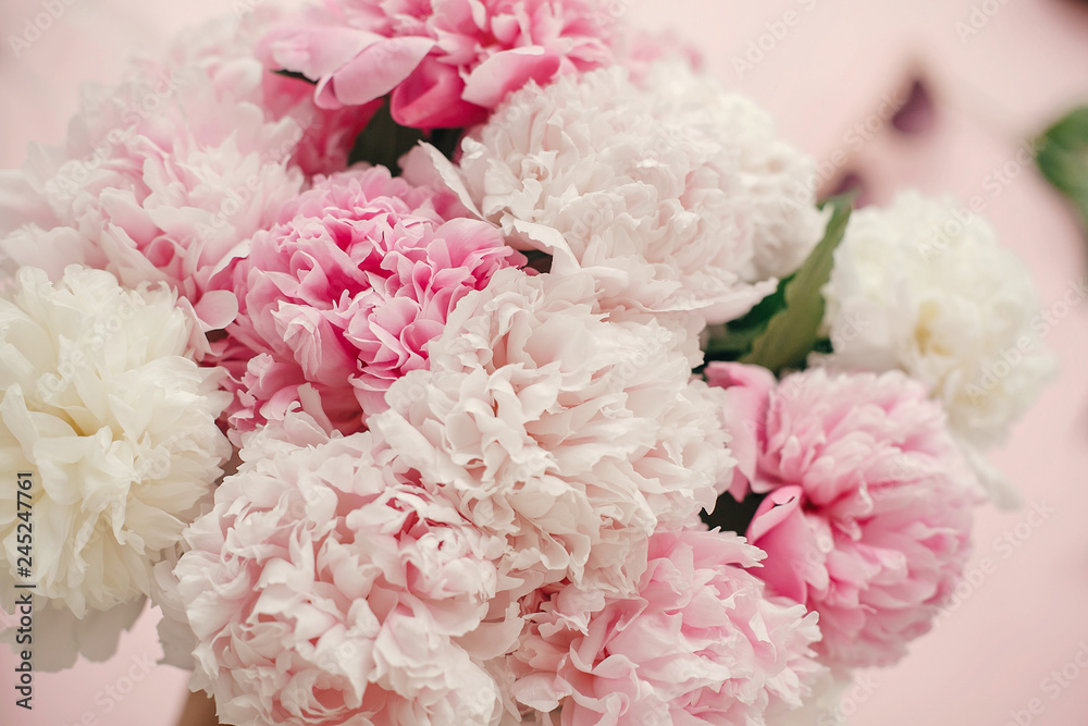 Stylish peonies bouquet flat lay. Pink and white peonies on pastel pink paper. Hello spring. Happy mothers day, floral greeting card mockup. International Womens Day. Valentines day Stylish peonies bouquet flat lay. Pink and white peonies on pastel pink paper. Hello spring. Happy mothers day, floral greeting card mockup. International Womens Day. Valentines day