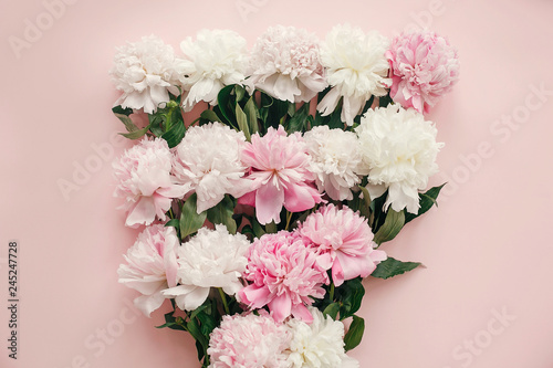 Fototapeta Naklejka Na Ścianę i Meble -  Hello spring.  Stylish peonies bouquet flat lay. Pink and white peonies on pastel pink paper. Happy mothers day, floral greeting card mockup. International Womens Day. Valentines day