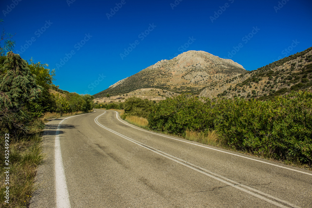 sunny bright colorful spring landscape with empty car road through mountain and green trees nature anvironment sunny bright colorful spring landscape with empty car road through mountain and green trees nature anvironment