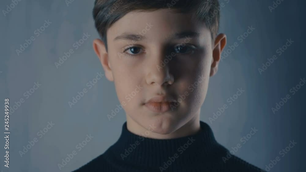close-up portrait of cute boy looking at camera close-up portrait of cute boy looking at camera