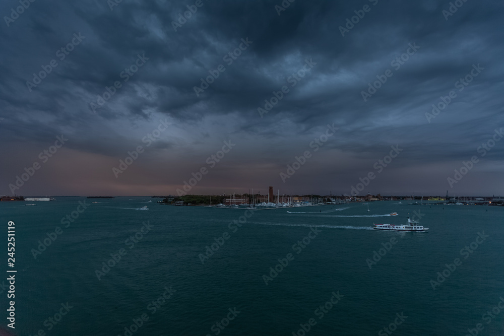 Thunderstorm at evening over Sant'Elena island in the Venice lagoon with boat traffic