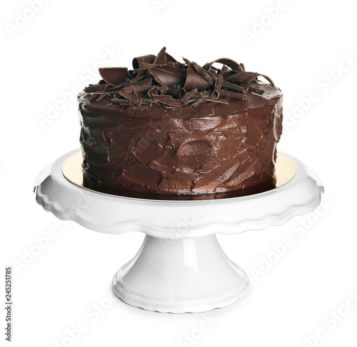 Stand with tasty homemade chocolate cake on white background