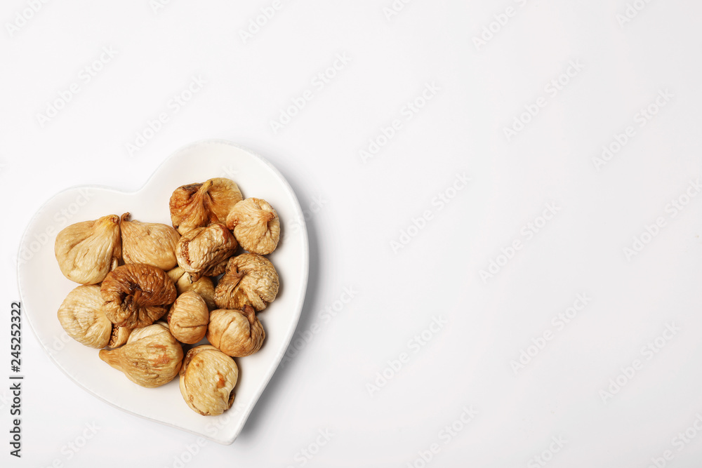 Plate of dried figs on white background, top view with space for text. Healthy fruit Plate of dried figs on white background, top view with space for text. Healthy fruit