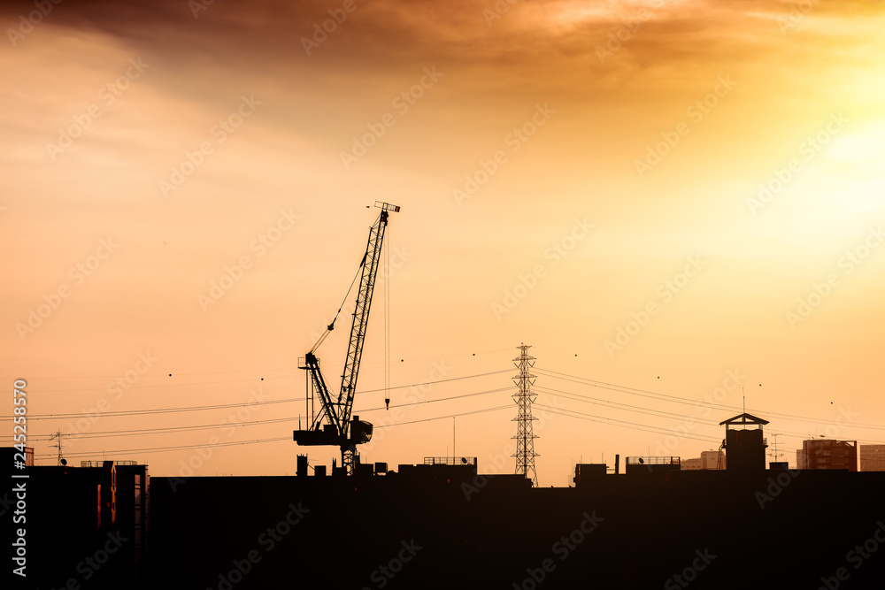 Construction site with cranes against Construction site with cranes against