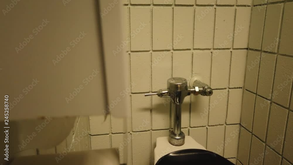 Close-up of a public restroom toilet paper holder with the toilet paper ...